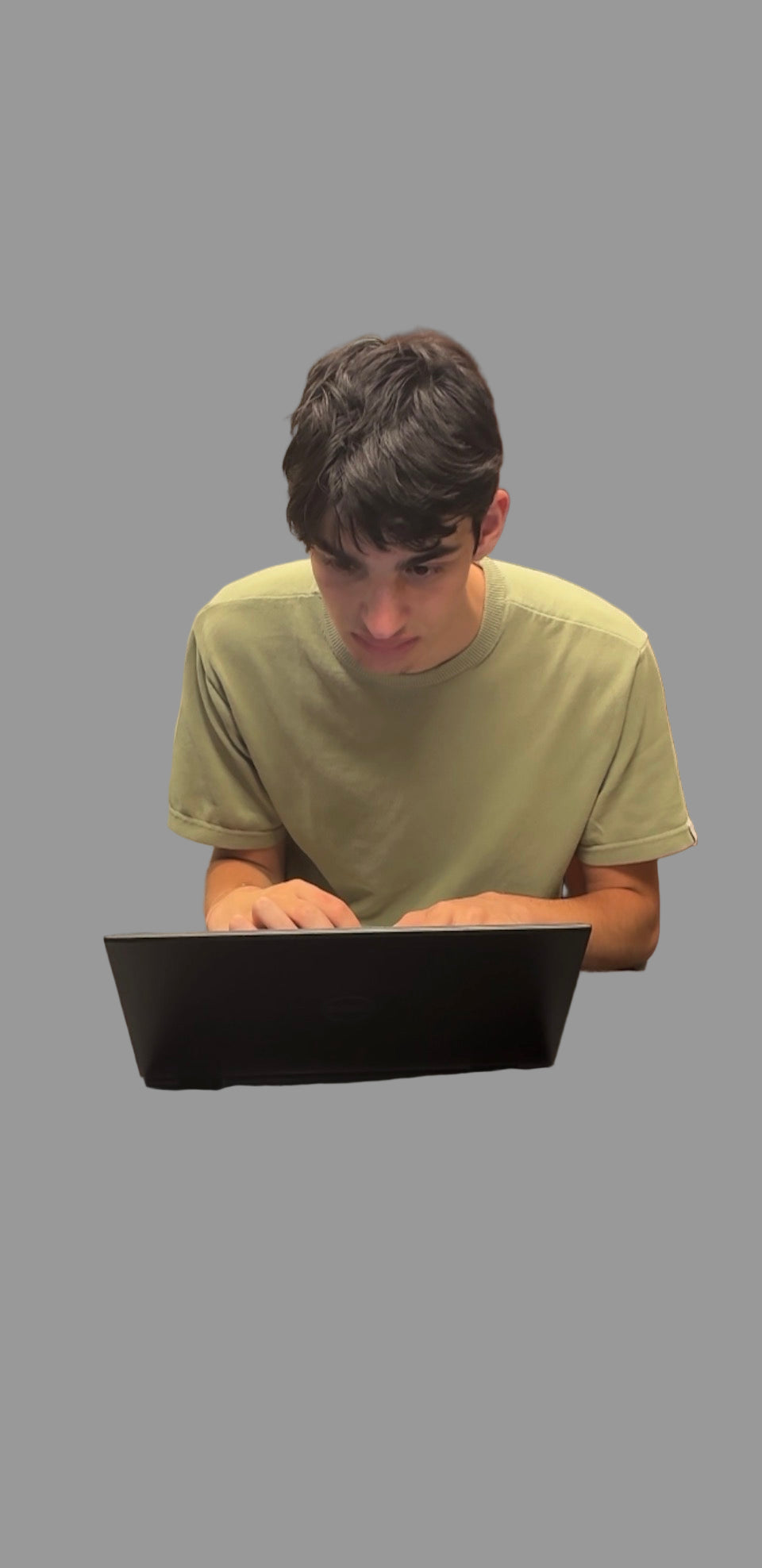 Person using a laptop at a desk in an indoor setting